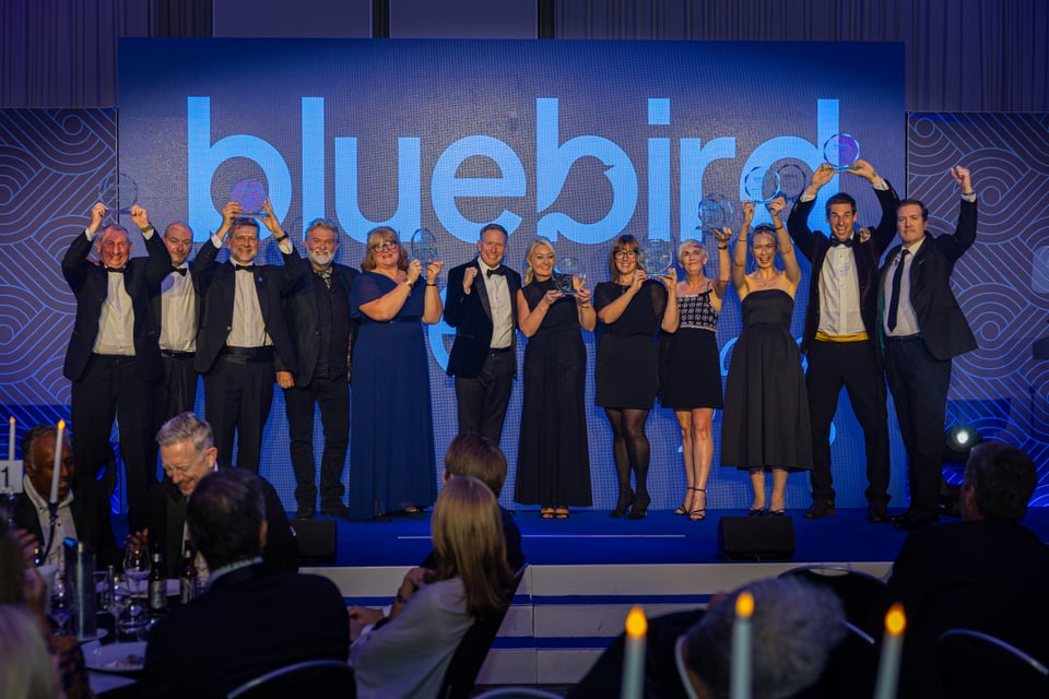 Bluebird Care Franchise Partners who won an award at the 2025 annual conference celebrating on stage.